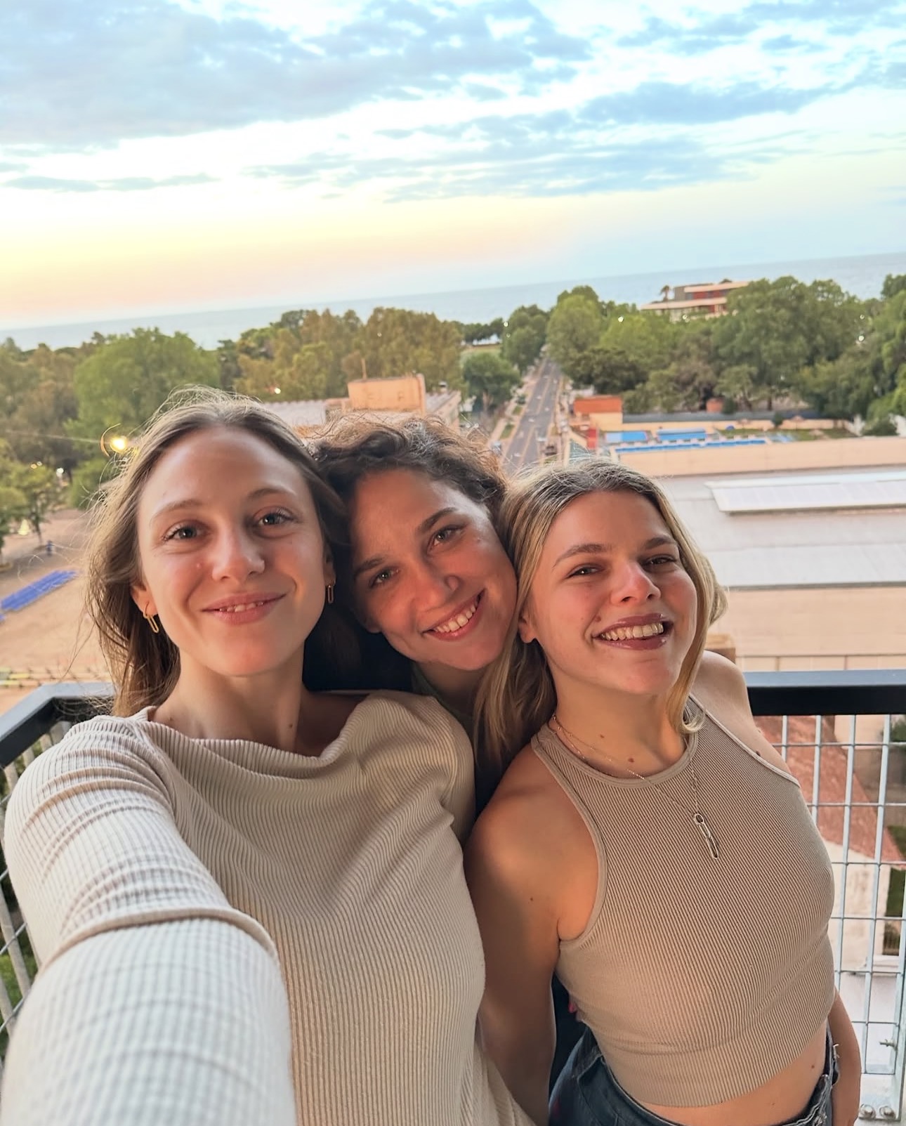 Friends taking a selfie on a balcony overlooking the city